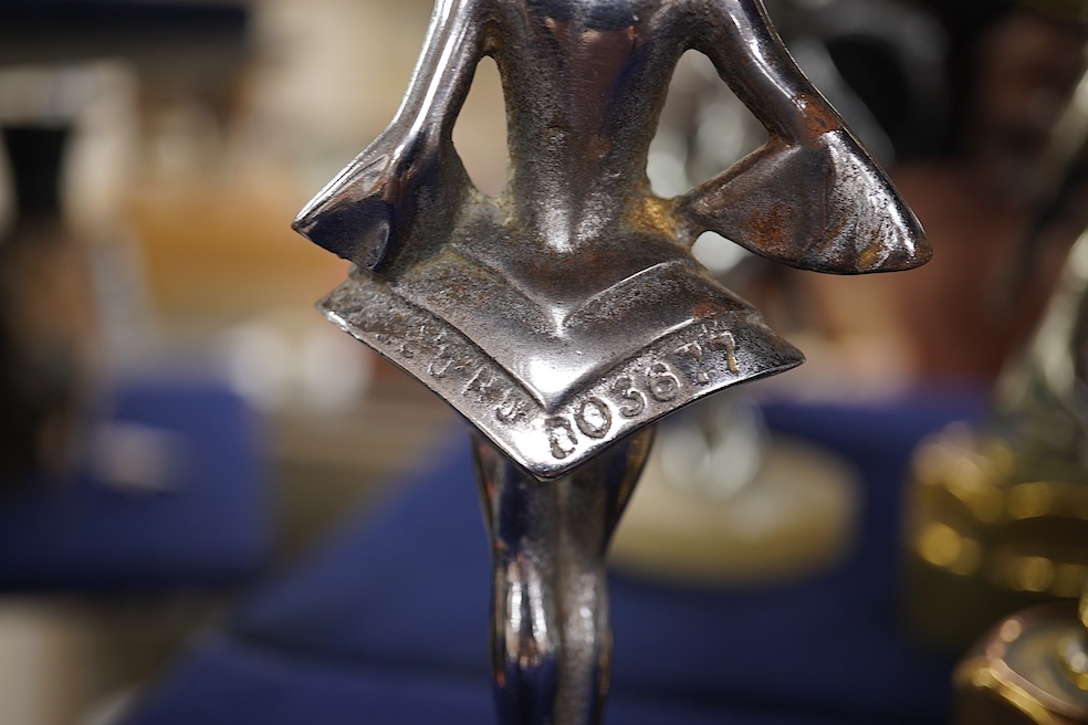 Five chrome car mascots in the form of female dancing figures, three mounted on threaded radiator caps, one with a registration number: 675619, one a stylised Art Deco winged female figure astride a globe. Condition - fa